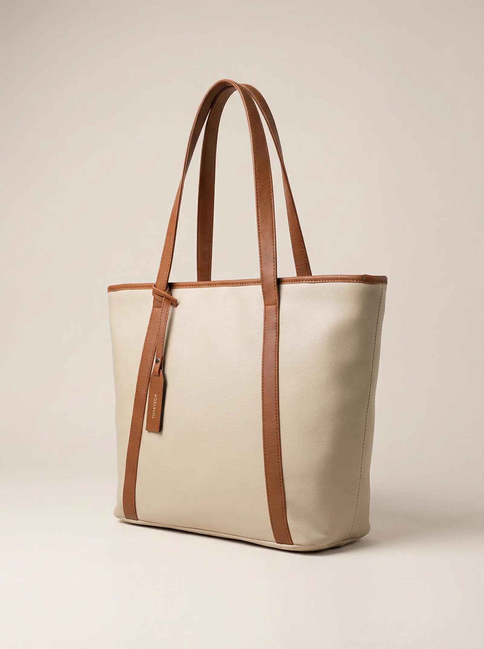 Cream Toteteca tote with contrast tan straps and trim