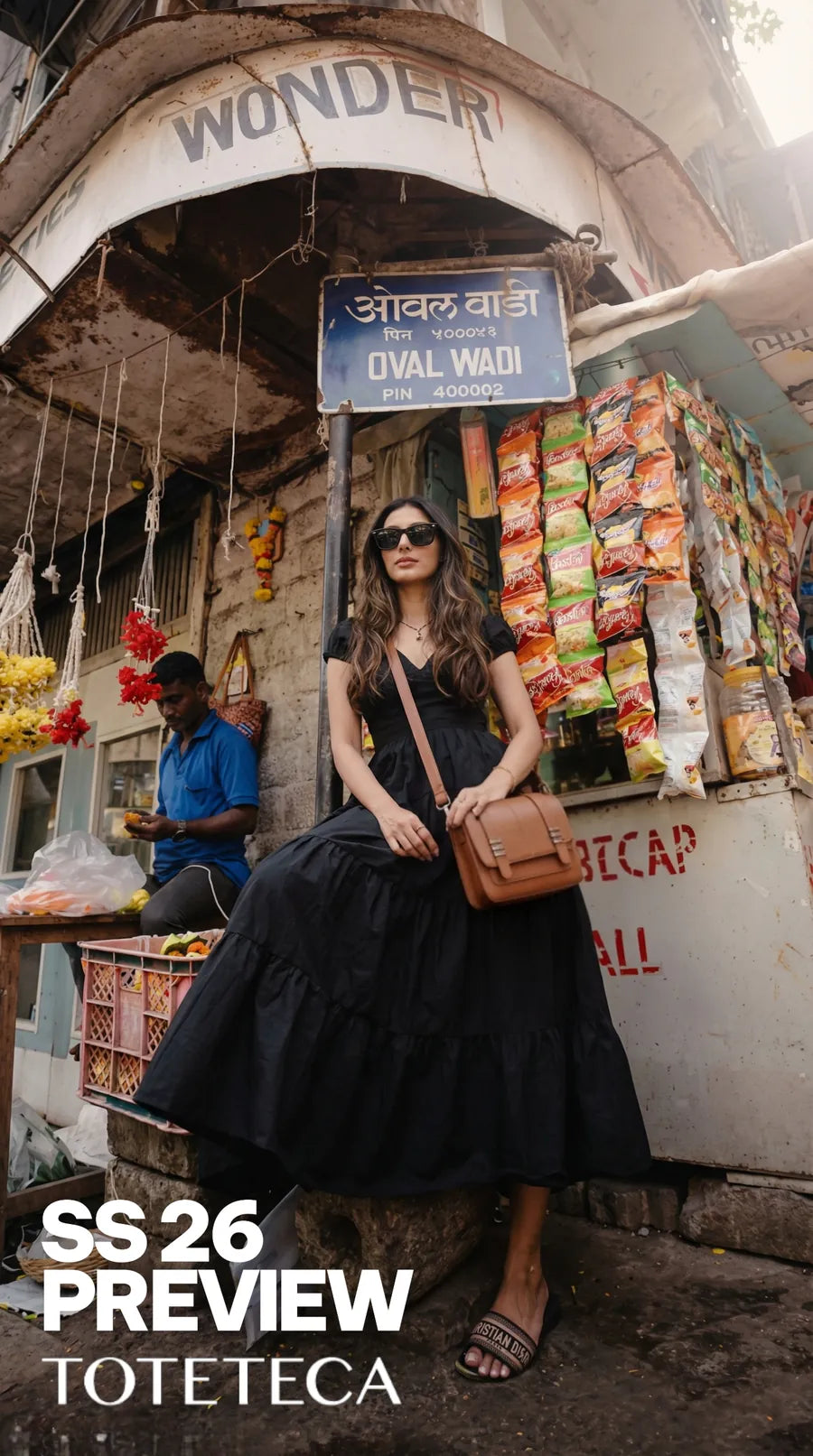 Toteteca SS26 preview - model in a black dress at a Mumbai street stall