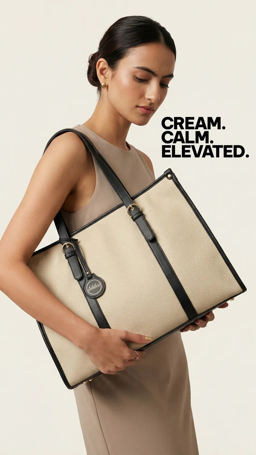 Model holding a cream Toteteca tote with black trim - cream, calm, elevated