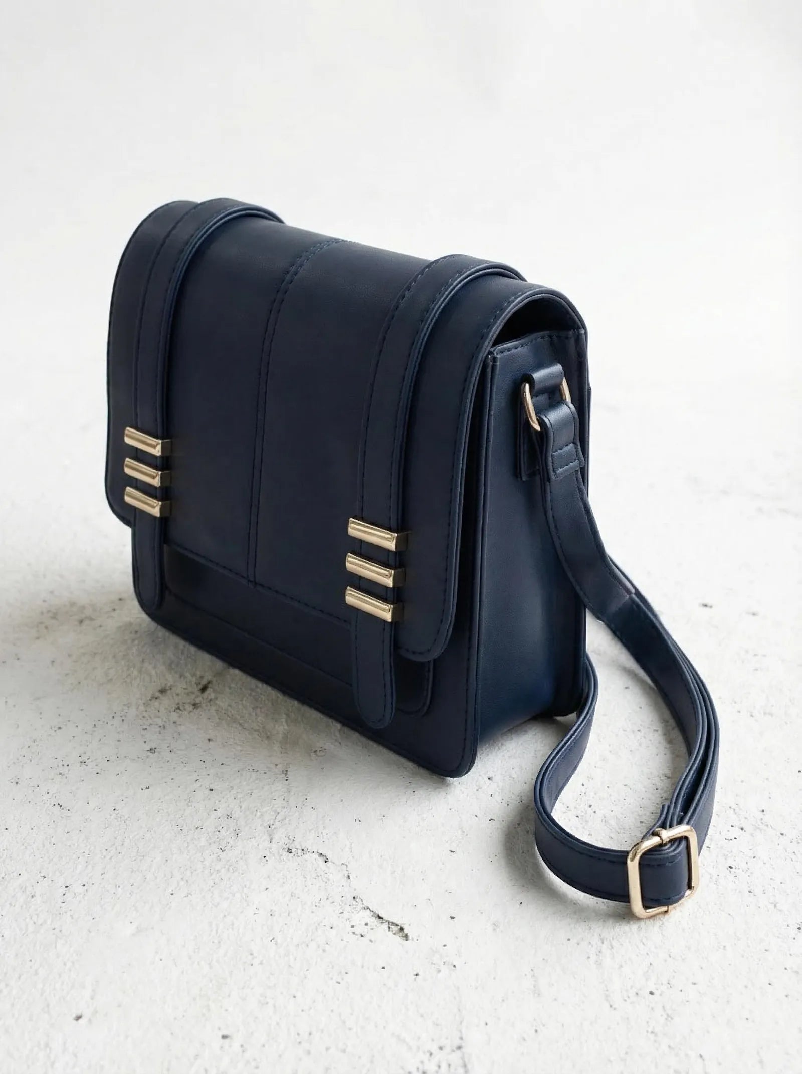 Navy Toteteca satchel with gold hardware and wide crossbody strap